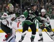 Stars right wing Mikko Rantanen skates in front of Wild goaltender Jesper Wallstedt as both watch the play.