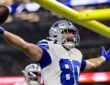 Dallas Cowboys tight end Mitch Van Vooren spreads his arms and holds up the ball after scoring a touchdown.