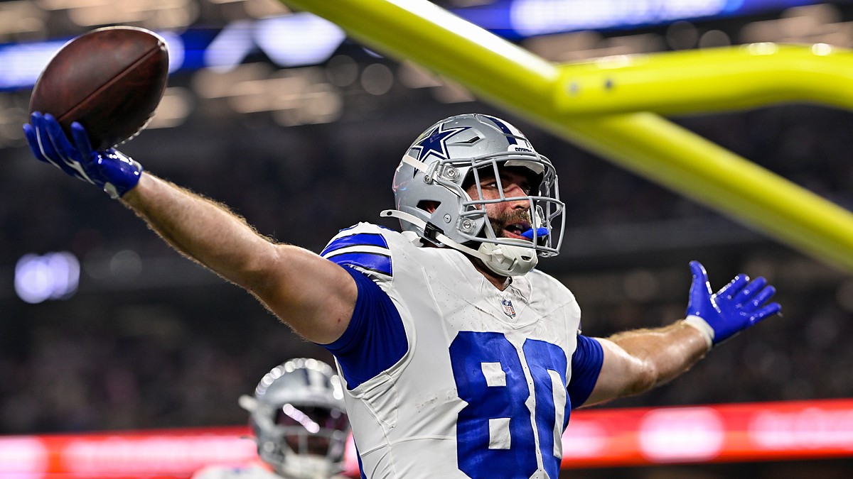 Dallas Cowboys tight end Mitch Van Vooren spreads his arms and holds up the ball after scoring a touchdown.