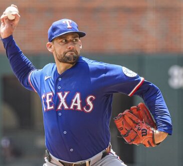 Texas Rangers right-hander Nathan Eovaldi, No. 17, brings his arm forward to deliver a pitch.