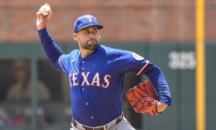 Texas Rangers right-hander Nathan Eovaldi, No. 17, brings his arm forward to deliver a pitch.