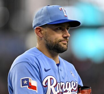 Texas Rangers starting pitcher Nathan Eovaldi walks off the field holding his glove during a game against the Padres.