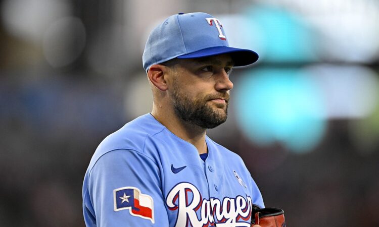 Texas Rangers starting pitcher Nathan Eovaldi walks off the field holding his glove during a game against the Padres.