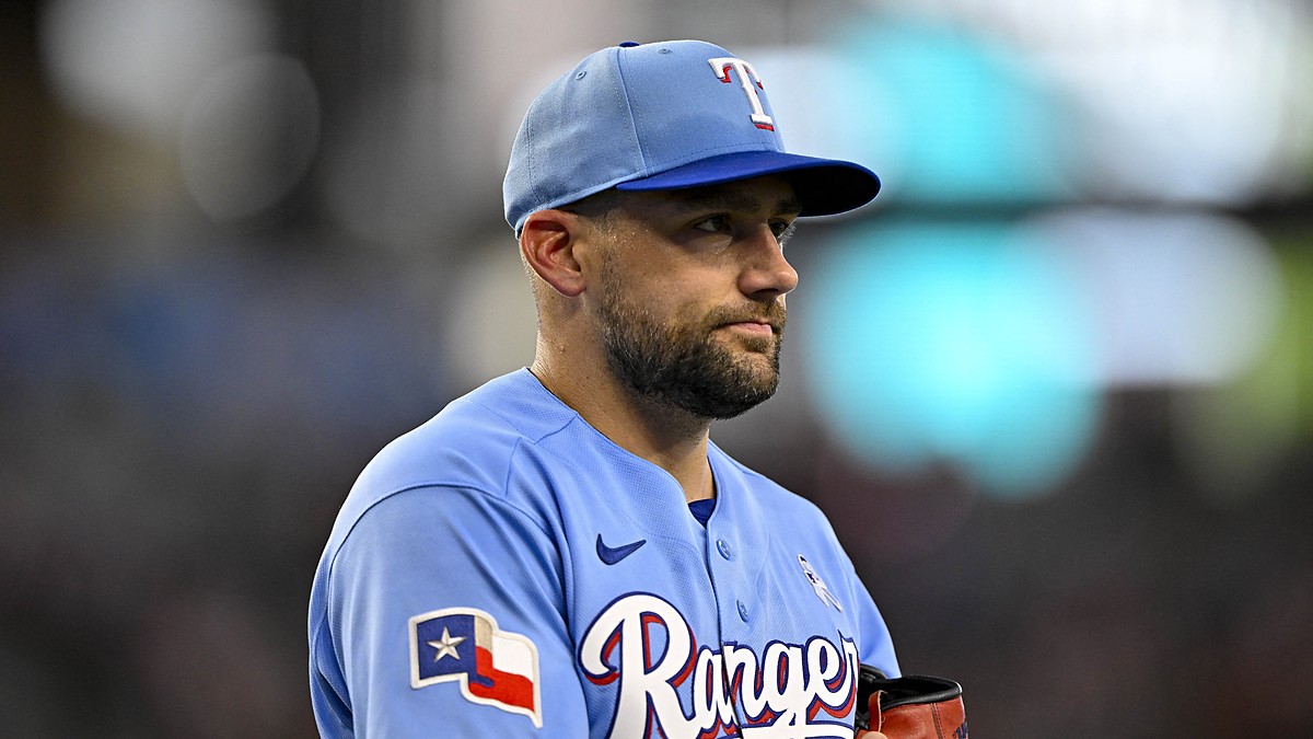 Texas Rangers starting pitcher Nathan Eovaldi walks off the field holding his glove during a game against the Padres.