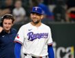 Texas Rangers pitcher Nathan Eovaldi smiles as he walks onto the field before a game against Boston.