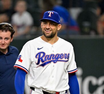 Texas Rangers pitcher Nathan Eovaldi smiles as he walks onto the field before a game against Boston.