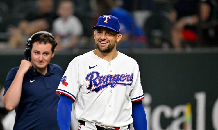 Texas Rangers pitcher Nathan Eovaldi smiles as he walks onto the field before a game against Boston.