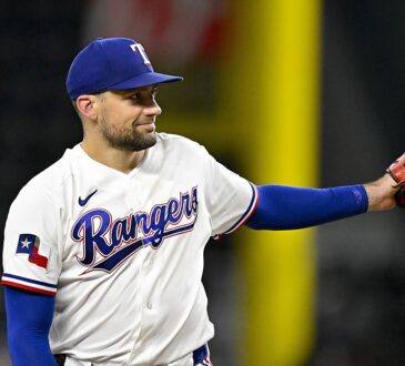 Rangers pitcher Nathan Eovaldi reaches out his glove for the ball on the mound.