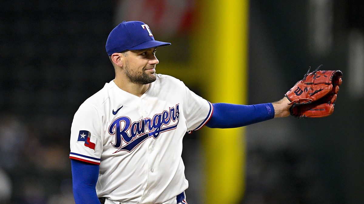 Rangers pitcher Nathan Eovaldi reaches out his glove for the ball on the mound.