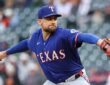 Texas Rangers starting pitcher Nathan Eovaldi extends his glove arm and brings the ball forward mid-delivery.
