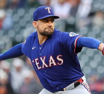Texas Rangers starting pitcher Nathan Eovaldi extends his glove arm and brings the ball forward mid-delivery.