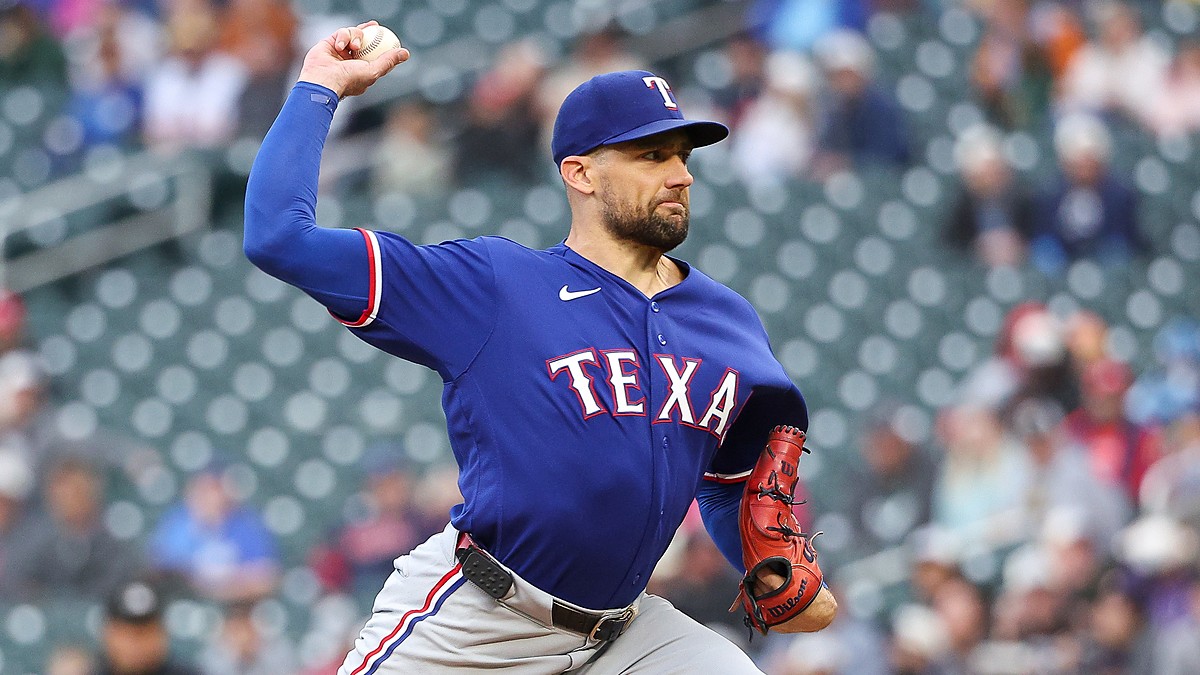 Texas Rangers starting pitcher Nathan Eovaldi rears back with the ball raised overhead as he delivers a pitch.