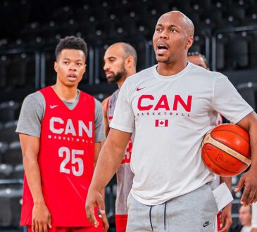 Canada Basketball assistant coach Nathaniel Mitchell calls out instructions while holding a basketball at practice.