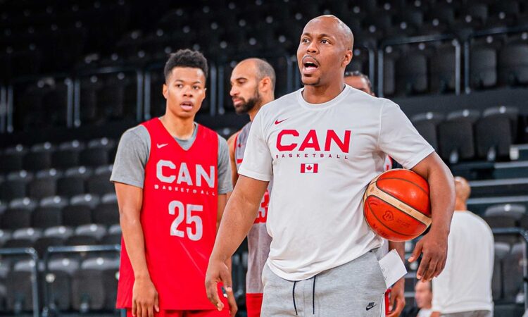 Canada Basketball assistant coach Nathaniel Mitchell calls out instructions while holding a basketball at practice.