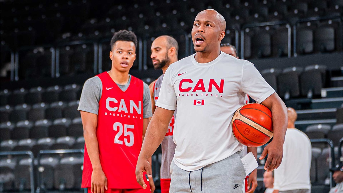 Canada Basketball assistant coach Nathaniel Mitchell calls out instructions while holding a basketball at practice.
