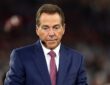 ESPN analyst Nick Saban wears a headset microphone while working on the broadcast set during a game.