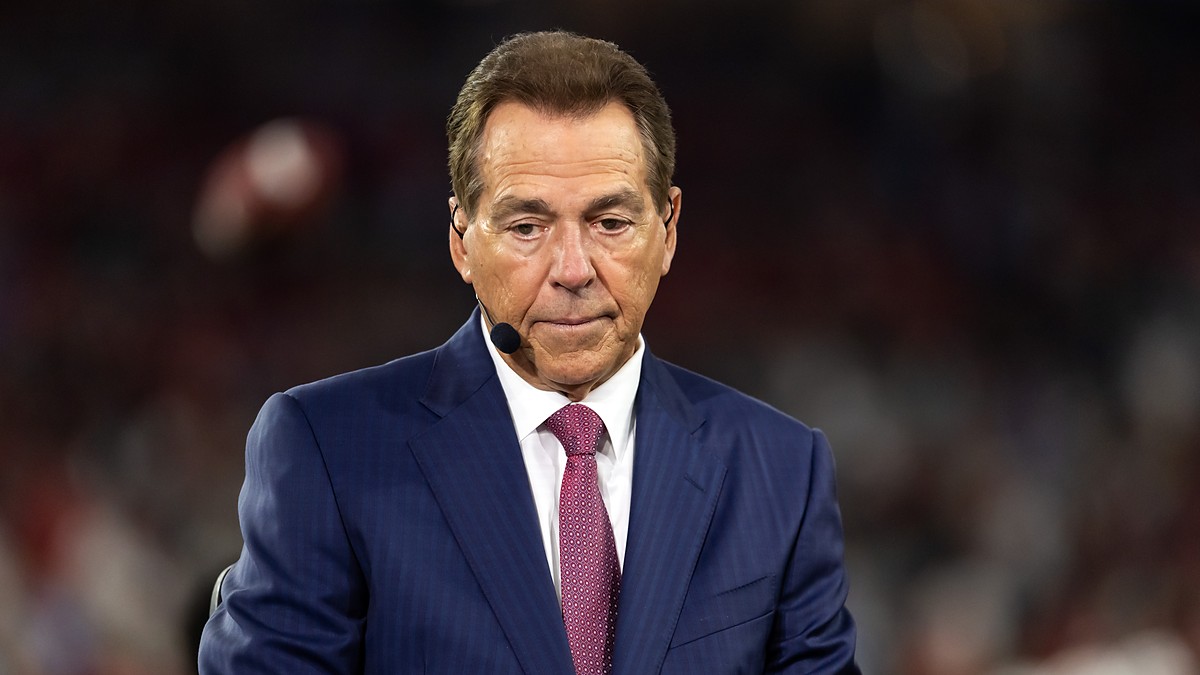 ESPN analyst Nick Saban wears a headset microphone while working on the broadcast set during a game.