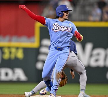 Texas Rangers infielder Nicky Lopez thrusts a fist toward the dugout after reaching second base against the Rays.