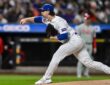 New York Mets starting pitcher Nolan McLean follows through on a pitch in a pinstriped Mets home uniform.