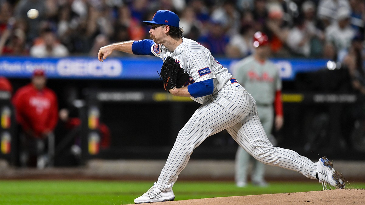 New York Mets starting pitcher Nolan McLean follows through on a pitch in a pinstriped Mets home uniform.