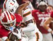 Indiana receiver Omar Cooper Jr. secures the ball as Miami defensive back OJ Frederique Jr. wraps him up.