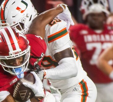 Indiana receiver Omar Cooper Jr. secures the ball as Miami defensive back OJ Frederique Jr. wraps him up.