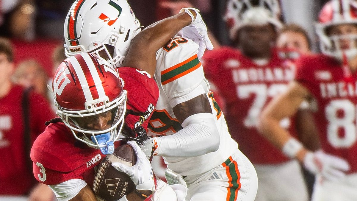 Indiana receiver Omar Cooper Jr. secures the ball as Miami defensive back OJ Frederique Jr. wraps him up.