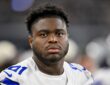 Dallas Cowboys defensive tackle Otito Ogbonnia looks toward the field from the sideline during a game against the Saints.