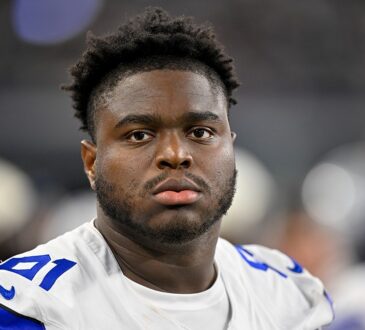 Dallas Cowboys defensive tackle Otito Ogbonnia looks toward the field from the sideline during a game against the Saints.