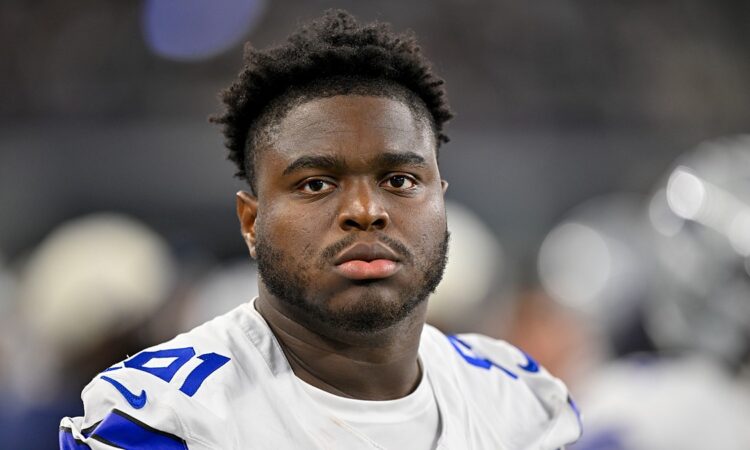 Dallas Cowboys defensive tackle Otito Ogbonnia looks toward the field from the sideline during a game against the Saints.