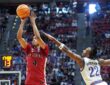 St. John’s guard Oziyah Sellers rises for a jump shot as Kansas guard Darryn Peterson stretches to contest it.
