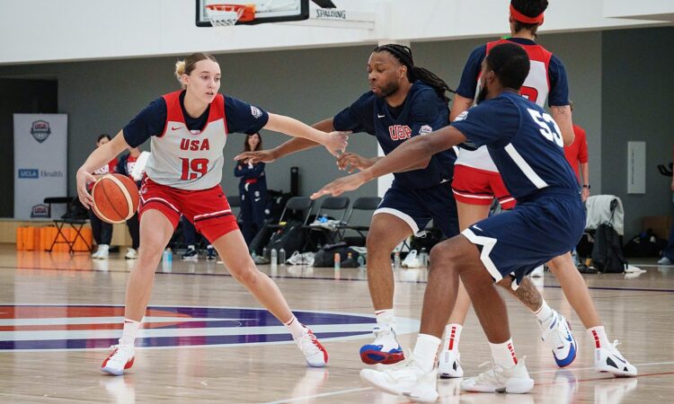 Dallas Wings guard Paige Bueckers dribbles against defenders during a Team USA practice.