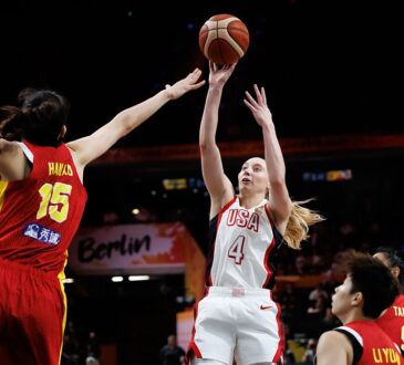 United States guard Paige Bueckers, No. 4, releases a jump shot as China center Han Xu contests with both arms raised.