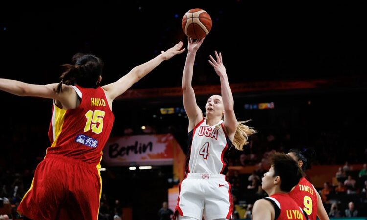 United States guard Paige Bueckers, No. 4, releases a jump shot as China center Han Xu contests with both arms raised.