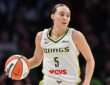 Dallas Wings guard Paige Bueckers dribbles up the floor in her white road uniform at Target Center.