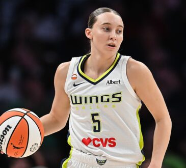 Dallas Wings guard Paige Bueckers dribbles up the floor in her white road uniform at Target Center.
