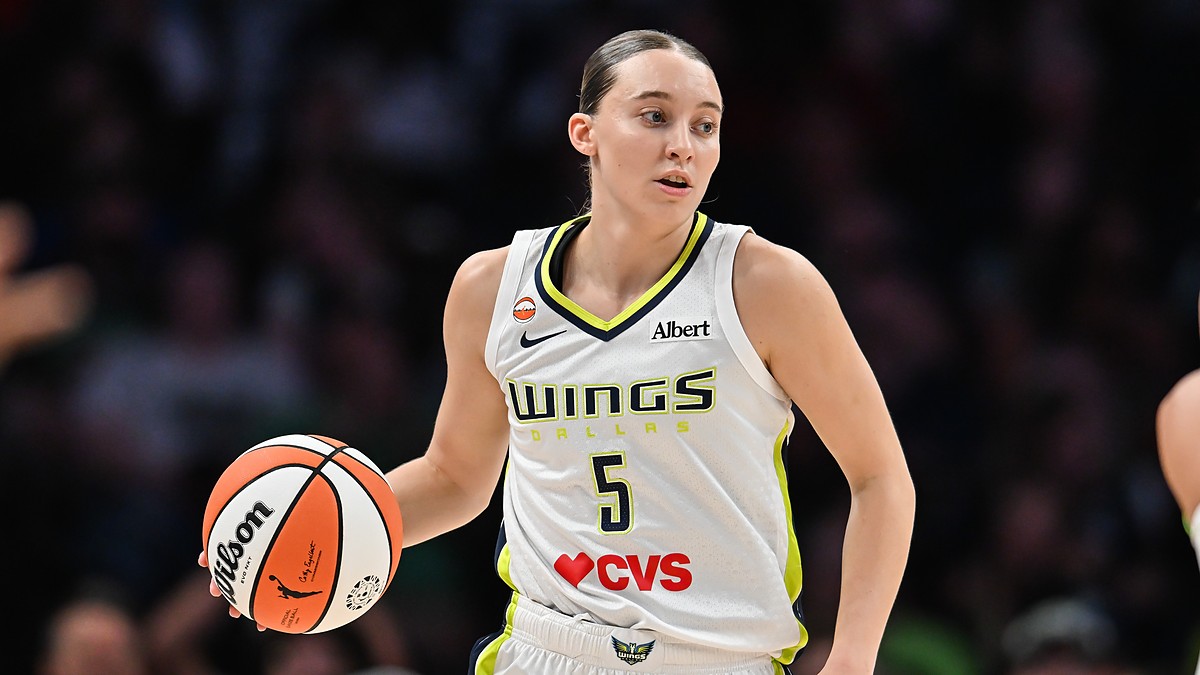Dallas Wings guard Paige Bueckers dribbles up the floor in her white road uniform at Target Center.