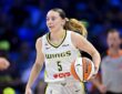 Dallas Wings guard Paige Bueckers dribbles up the court with the ball on her right hip.