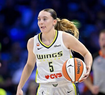 Dallas Wings guard Paige Bueckers dribbles up the court with the ball on her right hip.
