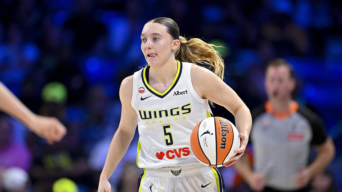 Dallas Wings guard Paige Bueckers dribbles up the court with the ball on her right hip.