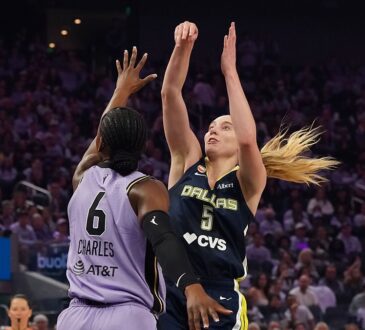 Dallas Wings guard Paige Bueckers rises for a jump shot over Golden State Valkyries guard-forward Kaila Charles.