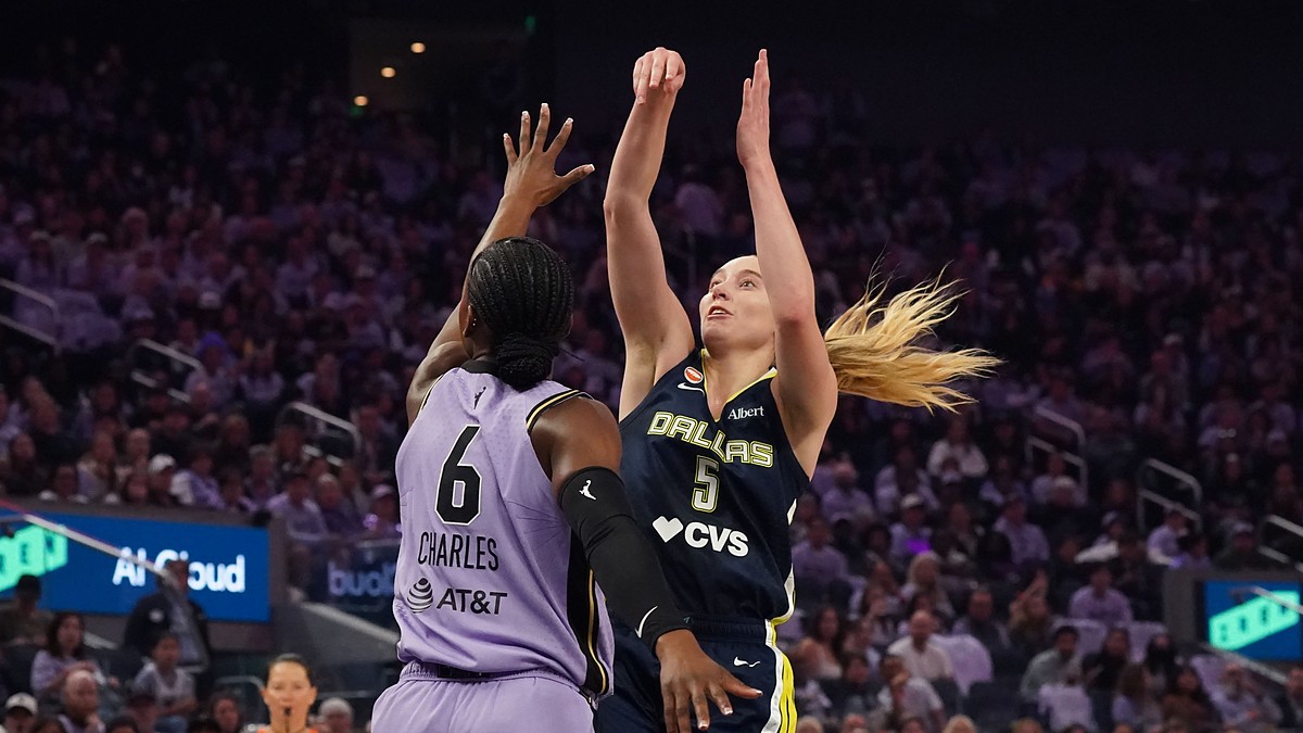 Dallas Wings guard Paige Bueckers rises for a jump shot over Golden State Valkyries guard-forward Kaila Charles.