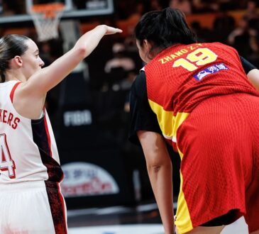 United States guard Paige Bueckers, No. 4, gestures beside China center Zhang Ziyu, No. 19, during a stoppage.
