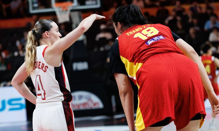United States guard Paige Bueckers, No. 4, gestures beside China center Zhang Ziyu, No. 19, during a stoppage.