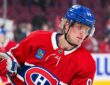 Montreal Canadiens right wing Patrik Laine holds his stick during warmups in a red home sweater.
