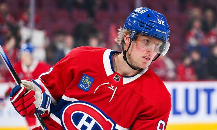 Montreal Canadiens right wing Patrik Laine holds his stick during warmups in a red home sweater.