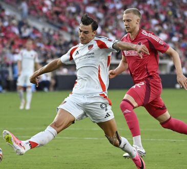 FC Dallas forward Petar Musa strikes the ball as St. Louis CITY SC defender Timo Baumgartl closes in.