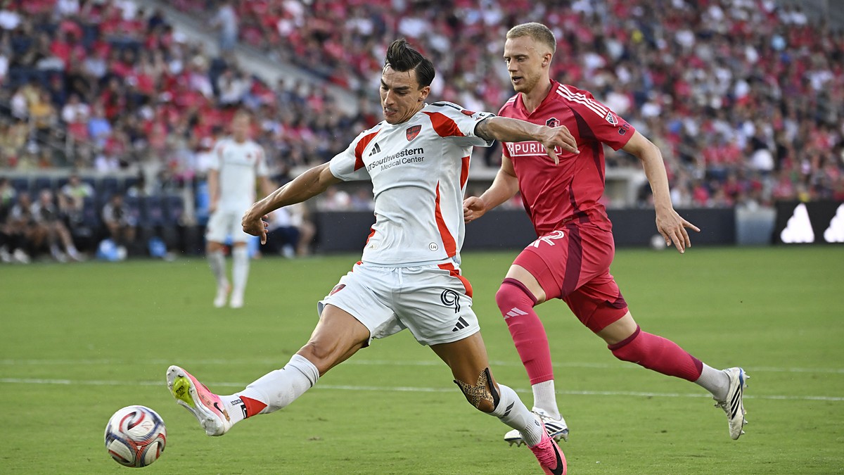 FC Dallas forward Petar Musa strikes the ball as St. Louis CITY SC defender Timo Baumgartl closes in.