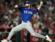 Texas Rangers pitcher Peyton Gray strides toward the plate mid-delivery in a road gray uniform.