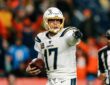 Los Angeles Chargers quarterback Philip Rivers points with the ball in his hand at Empower Field at Mile High.